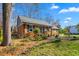 Charming brick home featuring mature trees and front landscaping at 2203 Canterbury Dr, Burlington, NC 27215