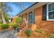 Inviting front porch with decorative wreath and well manicured landscaping at 2203 Canterbury Dr, Burlington, NC 27215