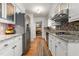 Kitchen featuring white cabinets, stainless steel appliances and ample counter space at 2203 Canterbury Dr, Burlington, NC 27215