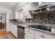 A kitchen featuring granite countertops and a stainless steel dishwasher and stove at 2203 Canterbury Dr, Burlington, NC 27215