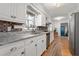 Bright kitchen features white cabinets, granite countertops, and stainless steel appliances at 2203 Canterbury Dr, Burlington, NC 27215