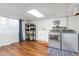 Modern laundry room with stainless steel washer and dryer, sink, and shelving at 2203 Canterbury Dr, Burlington, NC 27215