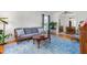 Bright living room featuring hardwood floors, a large rug, and ample seating at 2203 Canterbury Dr, Burlington, NC 27215