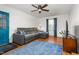 A living room with a gray leather couch, wood floors, and a blue rug at 2203 Canterbury Dr, Burlington, NC 27215