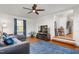 A living room with a gray leather couch, wood floors, and a blue rug at 2203 Canterbury Dr, Burlington, NC 27215