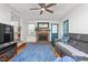 A living room with a brick fireplace, a blue rug and a gray leather couch at 2203 Canterbury Dr, Burlington, NC 27215
