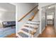 Interior staircase with wood railings and flooring, leading to the upper level at 2203 Canterbury Dr, Burlington, NC 27215
