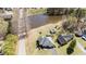 Aerial view of a house with a pond, green lawns, and a shed in a serene neighborhood at 248 Brookfield Cir, Sanford, NC 27330