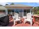 Spacious deck with two chairs, grill, and views of the backyard at 248 Brookfield Cir, Sanford, NC 27330