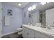 This bathroom features double sinks, a decorative mirror, and a walk-in shower at 248 Brookfield Cir, Sanford, NC 27330