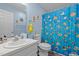 This bathroom has a sink, toilet, and a shower with a colorful fish-themed shower curtain at 248 Brookfield Cir, Sanford, NC 27330