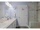 Bathroom featuring double sinks with a walk-in shower at 248 Brookfield Cir, Sanford, NC 27330