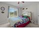 Cozy bedroom with ceiling fan, large window, and view of the outdoors at 248 Brookfield Cir, Sanford, NC 27330