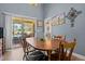 Open dining area with wooden table, access to sunroom, and backyard views at 248 Brookfield Cir, Sanford, NC 27330