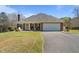 Brick home with attached garage, lawn, and covered front porch with seating at 248 Brookfield Cir, Sanford, NC 27330