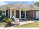Charming covered front porch with brick accents and a rocking chair on a well maintained lawn at 248 Brookfield Cir, Sanford, NC 27330