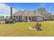 Charming brick home with well-manicured lawn, front porch and view of pond at 248 Brookfield Cir, Sanford, NC 27330