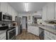 Functional kitchen with stainless steel appliances, granite countertops, and ample cabinet space at 248 Brookfield Cir, Sanford, NC 27330