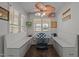 The breakfast nook features a lovely view of the yard, with custom seating and a ceiling fan at 248 Brookfield Cir, Sanford, NC 27330
