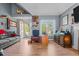Cozy living room featuring hardwood floors, comfortable seating, and natural light from a large window at 248 Brookfield Cir, Sanford, NC 27330