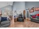 Open-concept living space with vaulted ceiling, hardwood floors, and seamless transition to dining area at 248 Brookfield Cir, Sanford, NC 27330