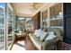 Relax in the sunroom with comfortable seating and views of the backyard, a perfect space for unwinding at 248 Brookfield Cir, Sanford, NC 27330