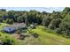 Aerial view of a single-story house and surrounding property with lush green trees at 2751 Old Fairground Rd, Angier, NC 27501