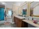Bathroom featuring double vanity with framed mirrors and a tub with shower at 2751 Old Fairground Rd, Angier, NC 27501