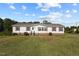 Well-maintained single-story home with a lush, green lawn under a bright blue sky at 2751 Old Fairground Rd, Angier, NC 27501