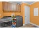 This well-equipped laundry room includes a washer, dryer, and storage cabinets for convenience at 2751 Old Fairground Rd, Angier, NC 27501