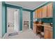 Room with teal-colored walls, desk with cabinets, and access to other rooms at 2751 Old Fairground Rd, Angier, NC 27501