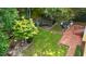 Aerial view of backyard with mature trees, stone patio and brick patio at 2812 Dahlgreen Rd, Raleigh, NC 27615