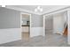 Bright open dining area featuring white chair rail and trim, a view into the kitchen, and hardwood floors at 2812 Dahlgreen Rd, Raleigh, NC 27615