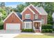 Beautiful brick home with a well-manicured lawn and trimmed shrubs at 2812 Dahlgreen Rd, Raleigh, NC 27615