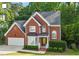Well-maintained two-story brick house with attached garage and manicured shrubs at 2812 Dahlgreen Rd, Raleigh, NC 27615