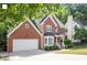 Stately two-story brick home with attached two-car garage and manicured lawn at 2812 Dahlgreen Rd, Raleigh, NC 27615