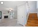 Bright foyer featuring hardwood floors, staircase, and open layout with seamless access to the living room at 2812 Dahlgreen Rd, Raleigh, NC 27615