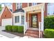 Charming front entrance with brick accents, well-kept landscaping, and a welcoming doorway, enhancing curb appeal at 2812 Dahlgreen Rd, Raleigh, NC 27615