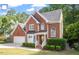 Charming brick home with a two-car garage, meticulously maintained landscaping, and inviting curb appeal at 2812 Dahlgreen Rd, Raleigh, NC 27615