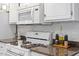 Updated kitchen features white cabinets, granite countertops, and stainless steel appliances at 2812 Dahlgreen Rd, Raleigh, NC 27615