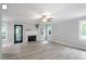 Bright living room with hardwood floors, a modern fireplace, and large windows overlooking the lush backyard at 2812 Dahlgreen Rd, Raleigh, NC 27615
