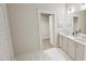 Bathroom with double vanity, modern fixtures, and a walk-in closet at 296 Beacon Dr, Pittsboro, NC 27312