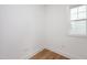 Minimalist bedroom with hardwood floors and a window with natural light at 296 Beacon Dr, Pittsboro, NC 27312