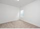 Bedroom featuring neutral walls, carpet flooring, and one window letting in natural light at 296 Beacon Dr, Pittsboro, NC 27312