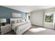 Serene bedroom with blue accent wall, plush bedding, and ample natural light at 296 Beacon Dr, Pittsboro, NC 27312