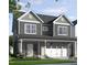 Charming two-story home with a brick-accented front porch and a two-car garage at 296 Beacon Dr, Pittsboro, NC 27312