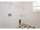 Laundry room with tiled floor, shelving, and neutral walls provides a functional space at 296 Beacon Dr, Pittsboro, NC 27312