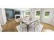Open-concept living and dining area with large windows and hardwood floors at 296 Beacon Dr, Pittsboro, NC 27312