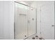 Modern bathroom featuring a glass enclosed shower with white subway tile and patterned floor at 296 Beacon Dr, Pittsboro, NC 27312