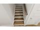 Stairway with wood treads and white risers, showcasing clean lines and neutral tones at 296 Beacon Dr, Pittsboro, NC 27312